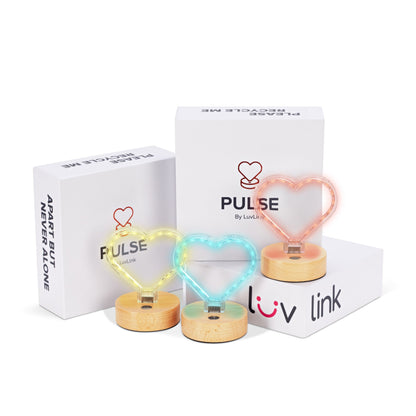 Wooden-based heart lamps in warm yellow, cool blue and coral neon glow beside Pulse packaging.