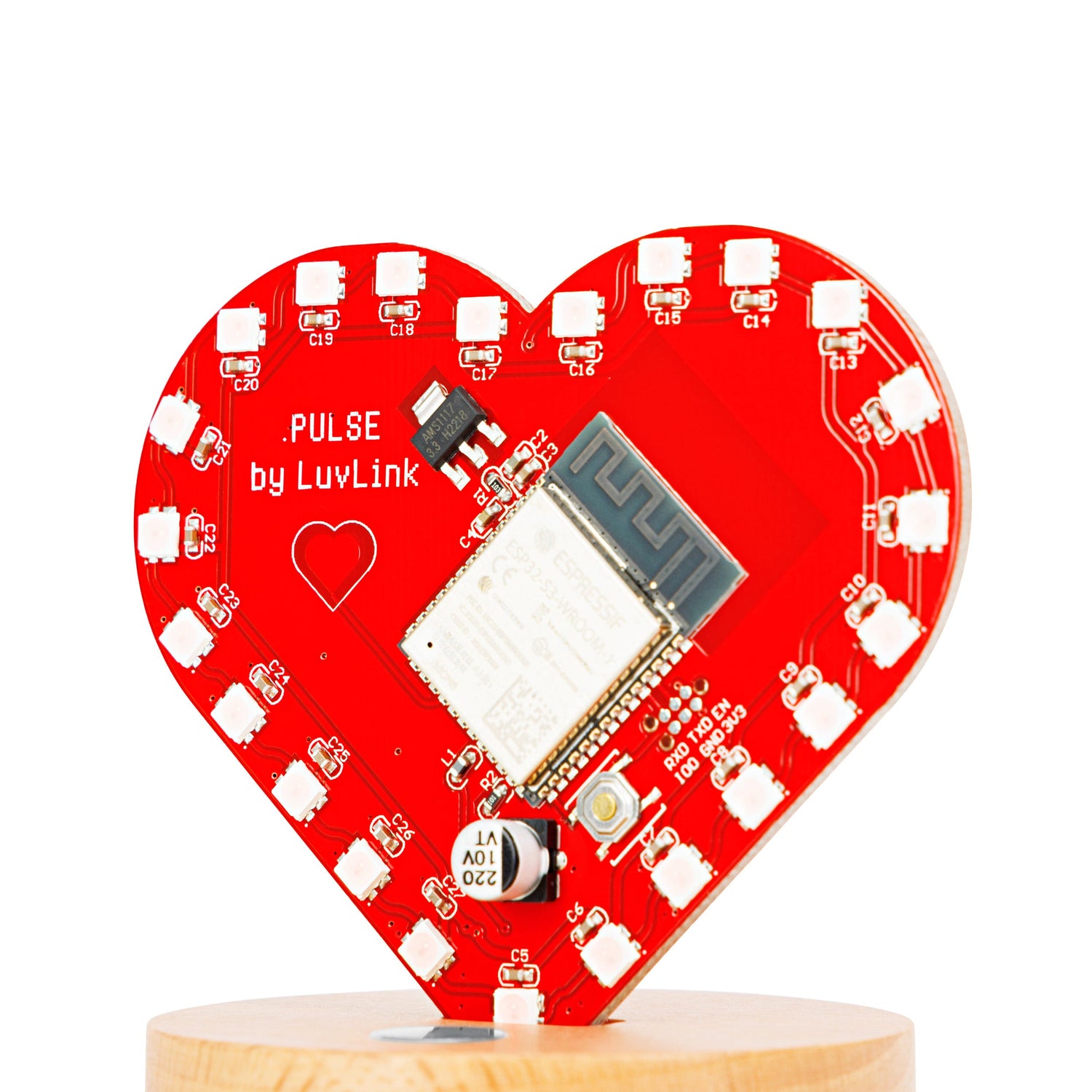 LuvLink Pulse heart-shaped circuit board displaying electronics and white LED components on red.