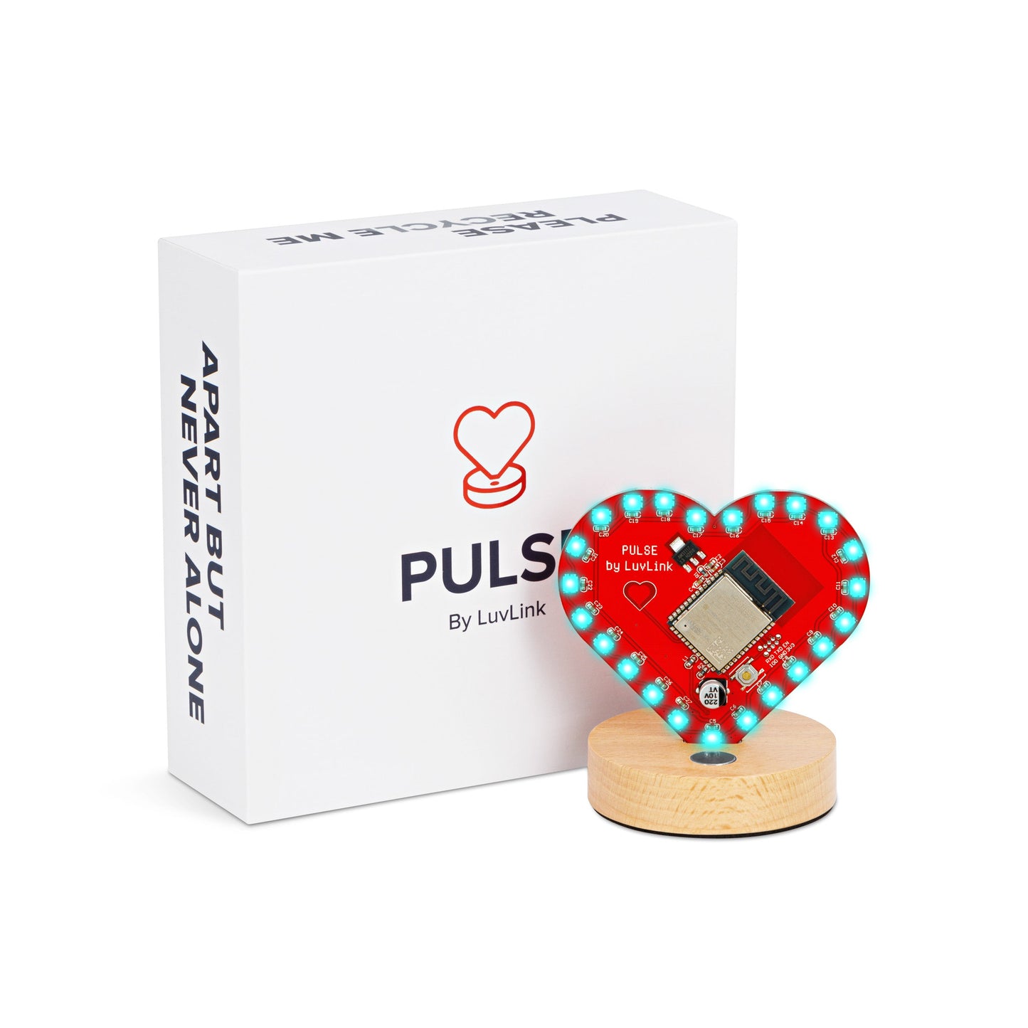 Pulse friendship lamp in a red heart shape with turquoise LEDs sits on a wooden base beside white packaging.