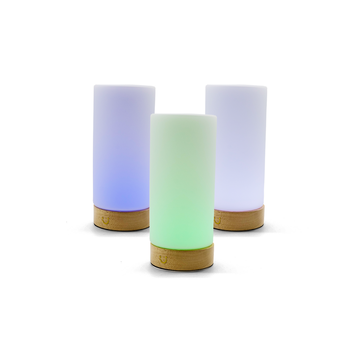 Glowing cylinder lamps with wooden bases in blue, green and purple arranged in a triangular formation.