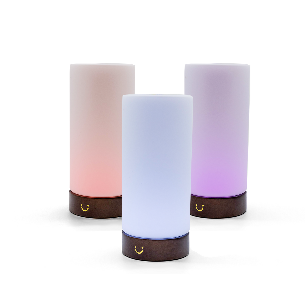 Frosted cylindrical lamps with dark wooden bases illuminated in soft pink, blue and purple hues.