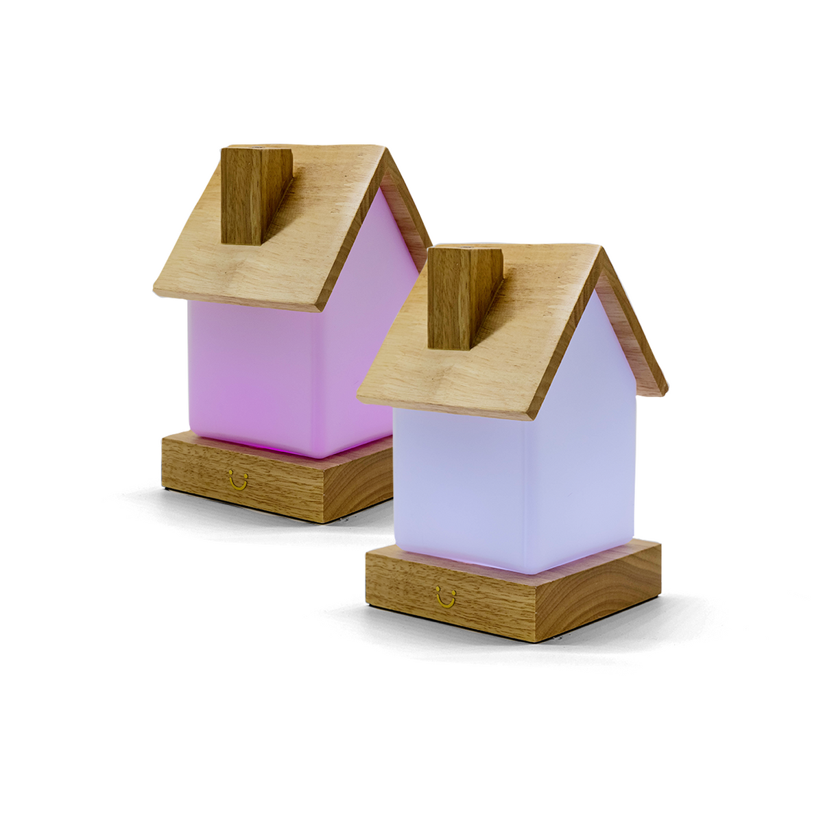 House-shaped lamps with wooden roofs in pink and lavender glow softly side by side.