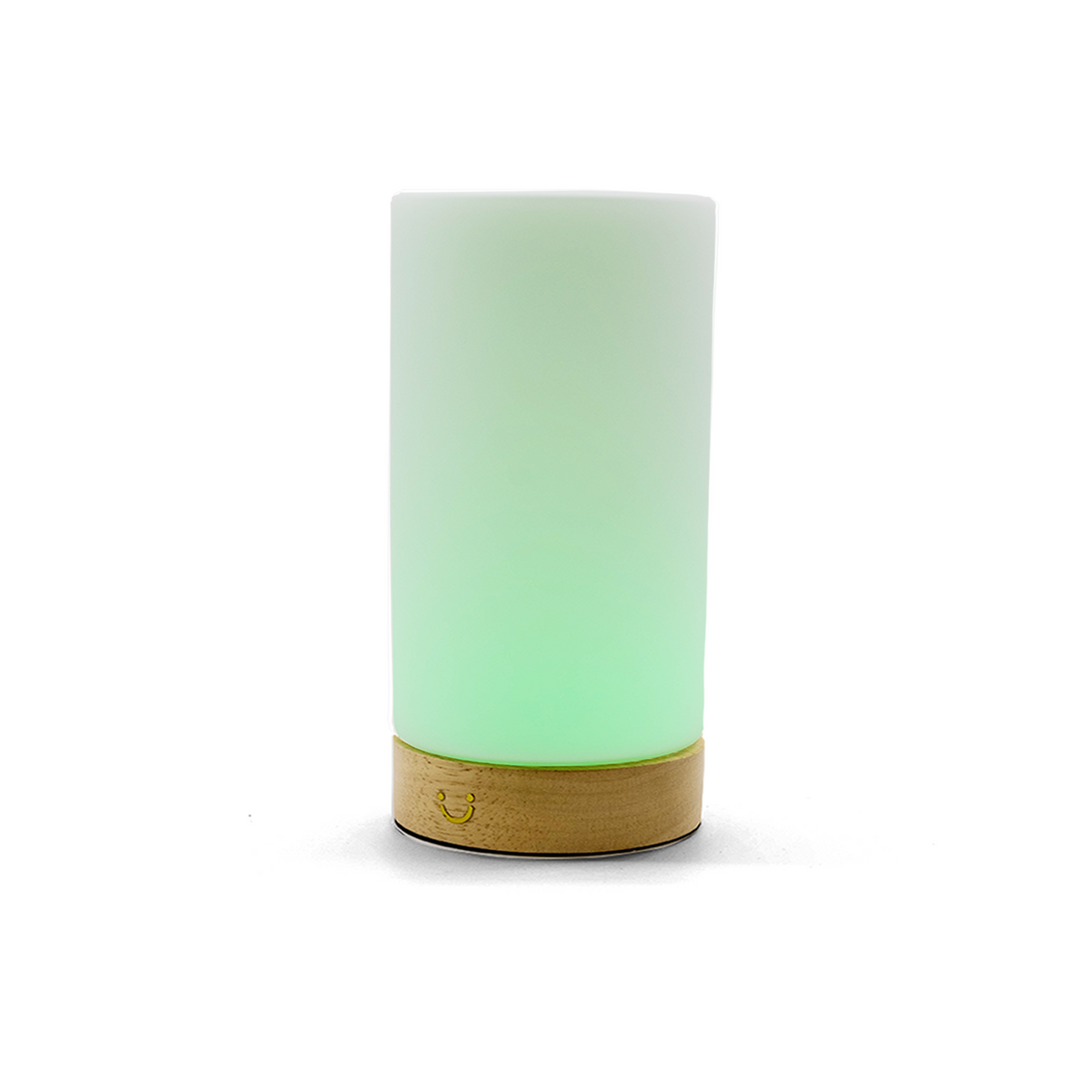 Cylindrical friendship lamp emitting soft green light from its frosted glass body and timber base.
