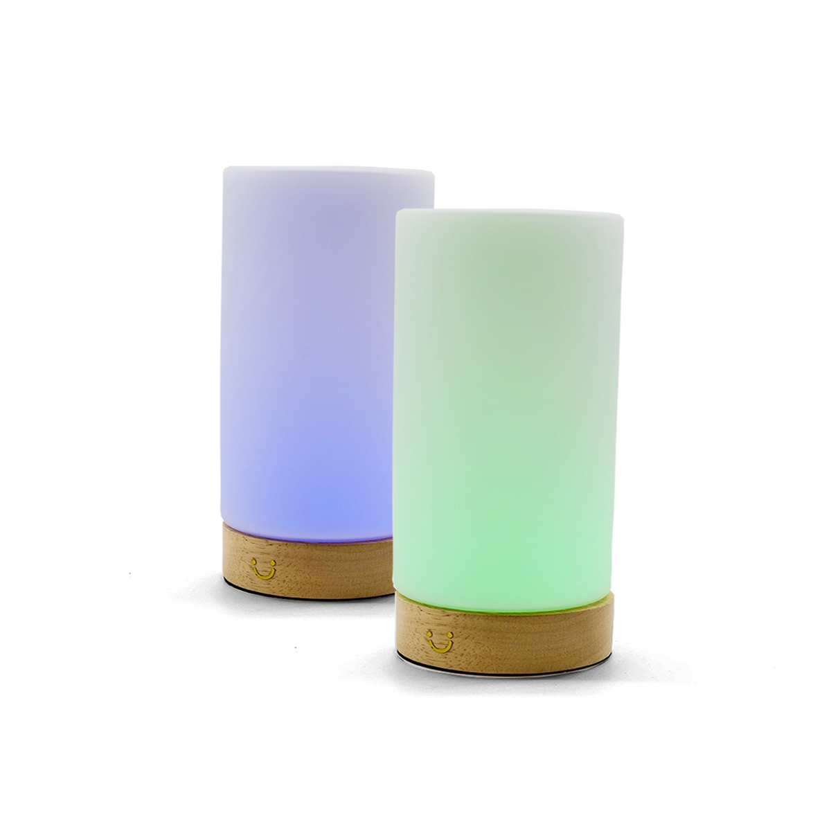 Friendship lamps with cylindrical frosted glass shades and timber bases, one casting blue light and the other green.